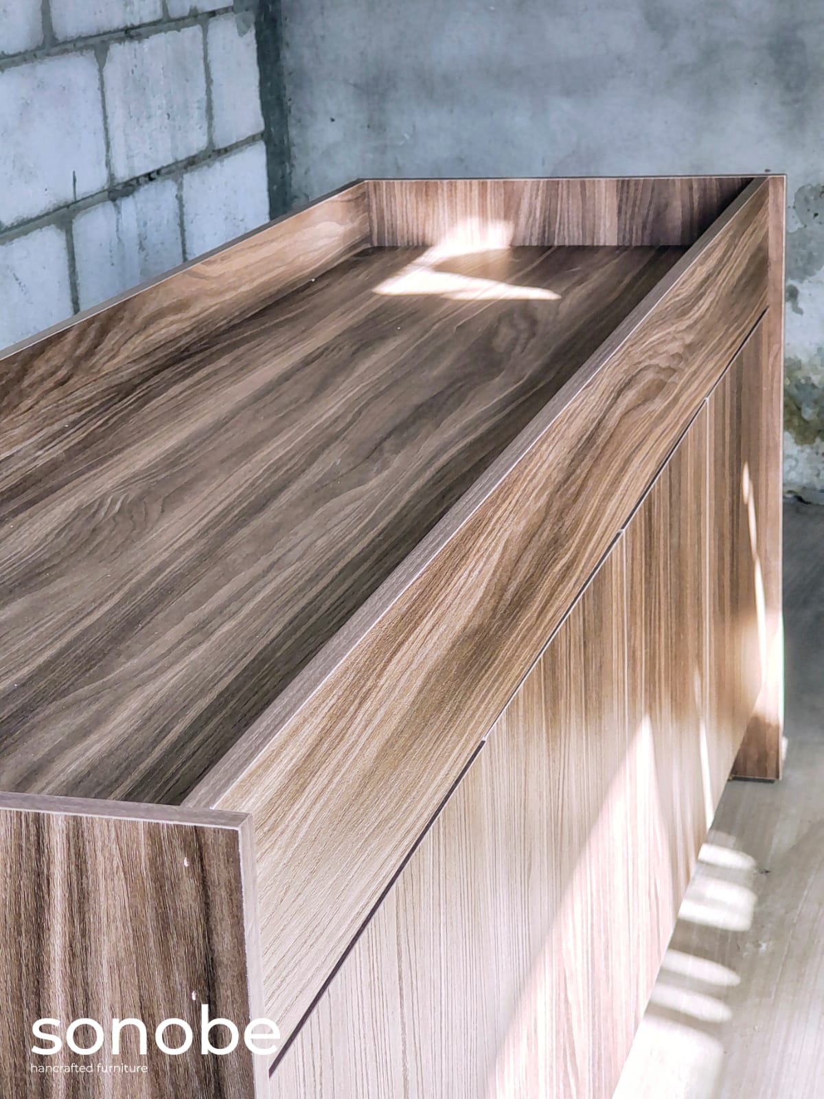 walnut credenza ii — angled top view with raised tray